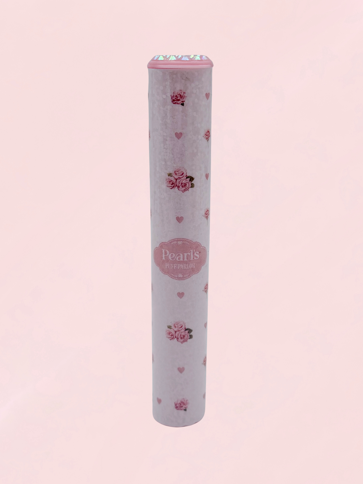 Single pink rosebud and heart print doob tube with rhinestone lid standing upright on a pink background