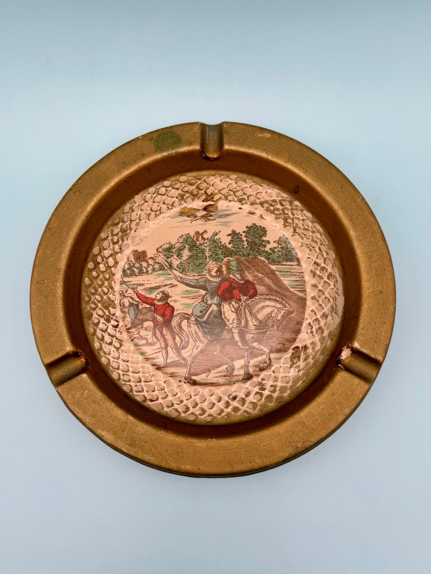 Close-up of the Florentine ashtray's painted landscape scene with horseback riders, gray background