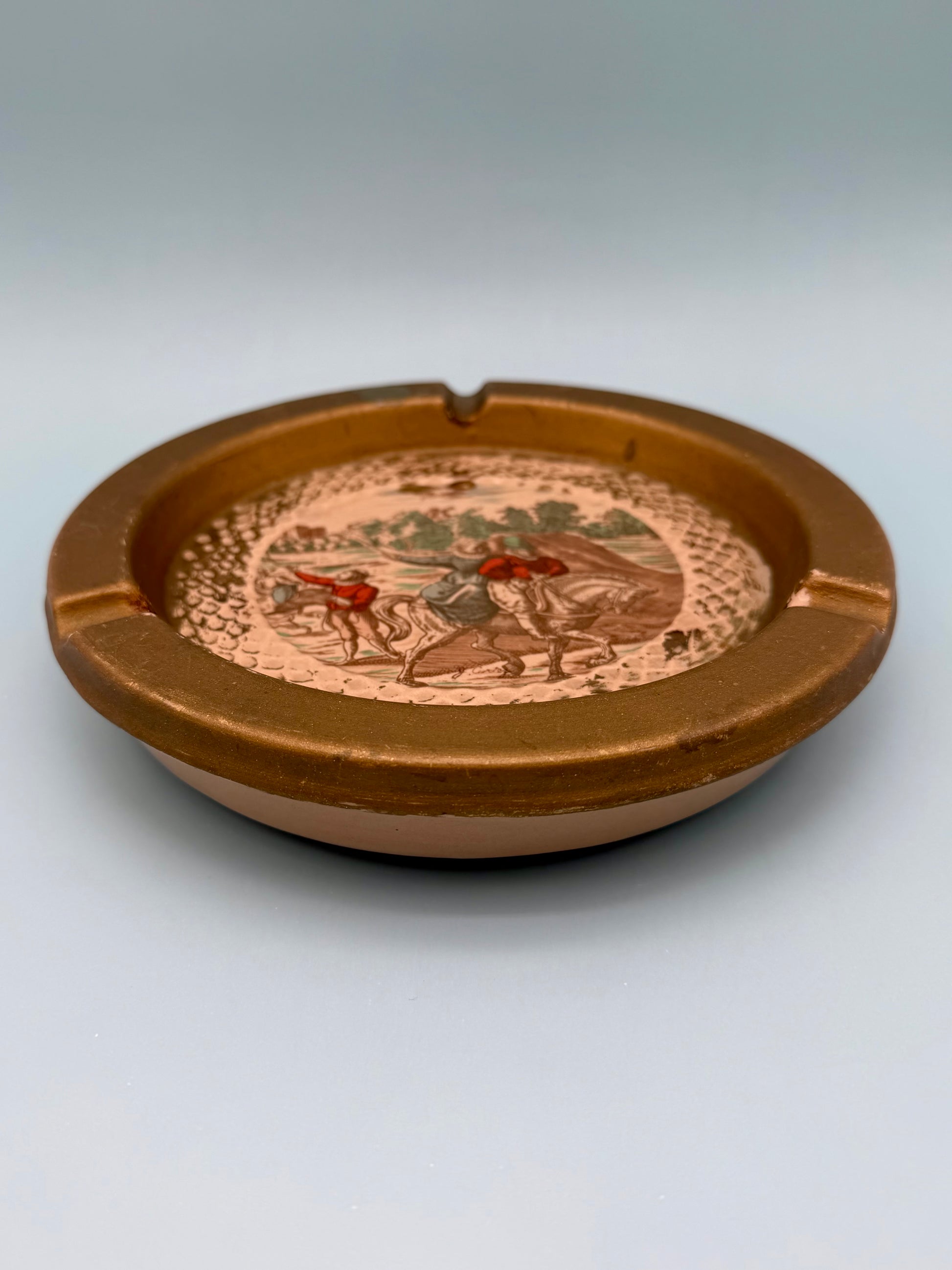 Florentine landscape ashtray shown from a side profile angle, gray background