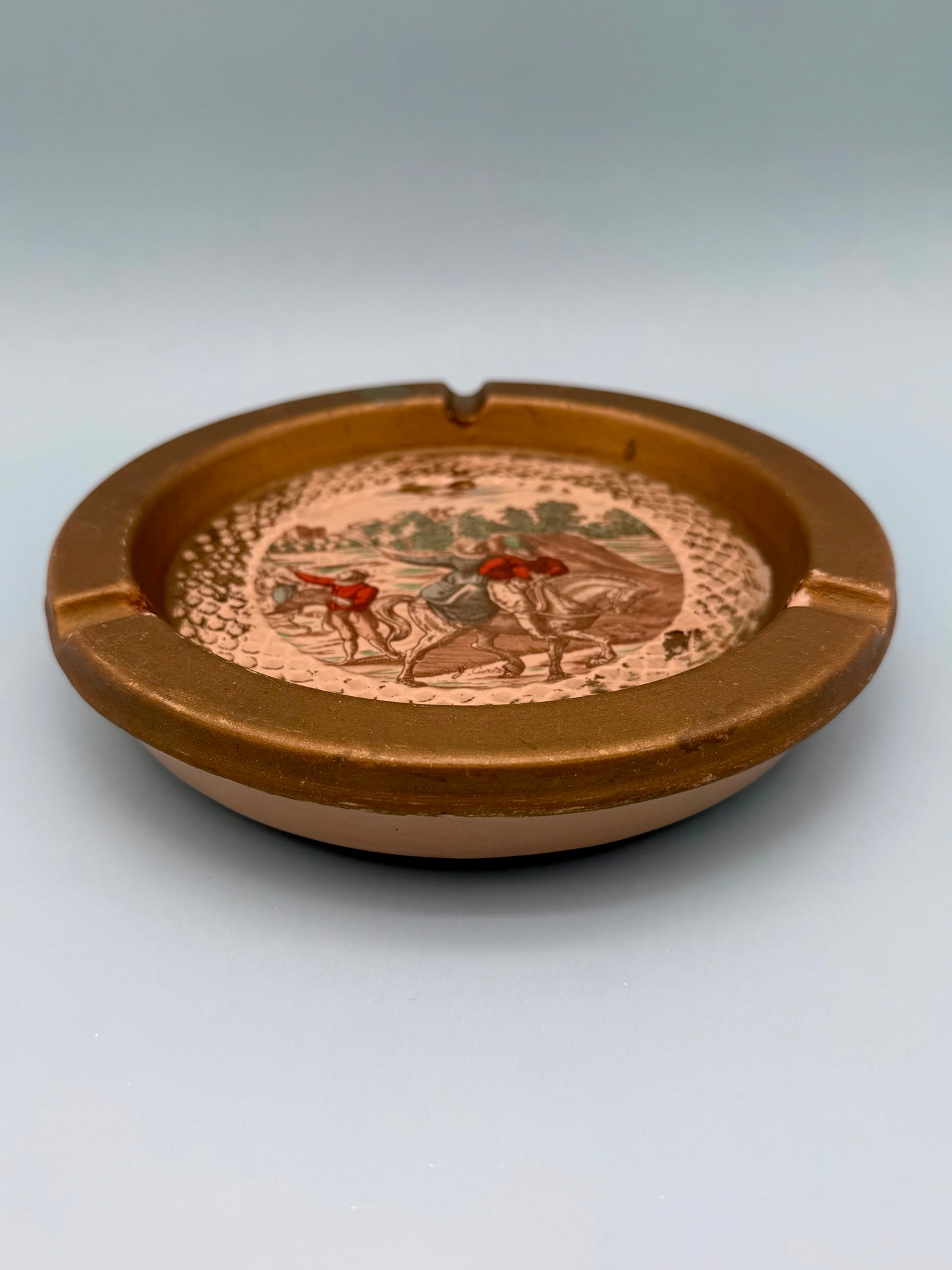 Florentine landscape ashtray shown from a side profile angle, gray background
