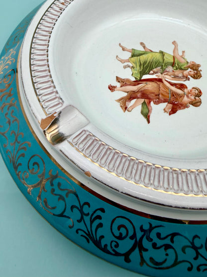 Close-up of the gold scrollwork trim and dancing figures medallion from a different angle, turquoise porcelain