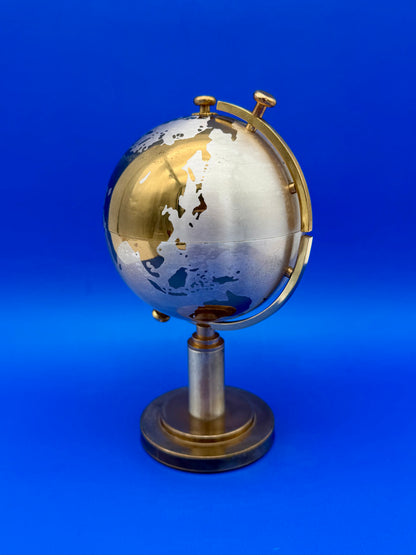 Brass globe cigarette holder closed, shown from a different angle on its pedestal stand