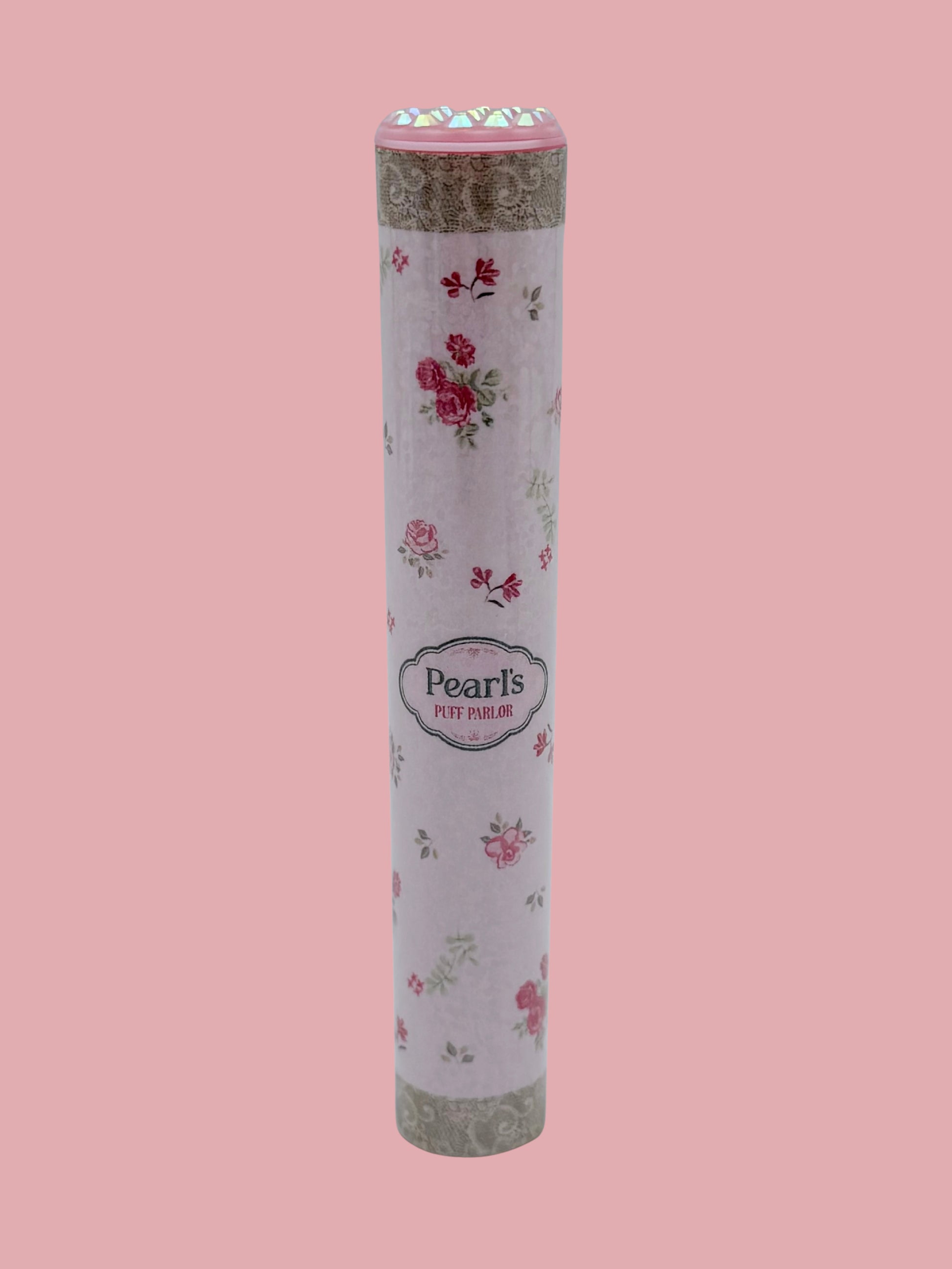 Single pink rose floral doob tube with rhinestone lid standing upright on a pink background