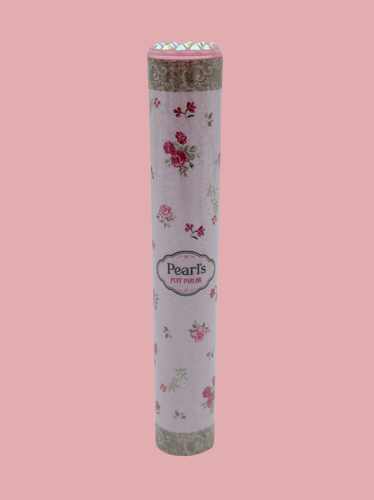 Single pink rose floral doob tube with rhinestone lid standing upright on a pink background