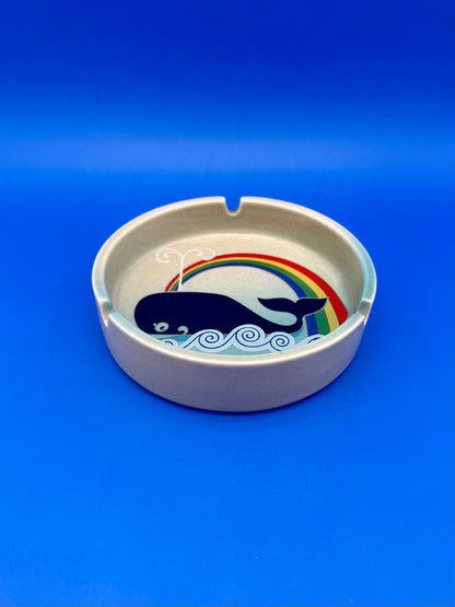 Same whale and rainbow ashtray shown from a different angle, blue background