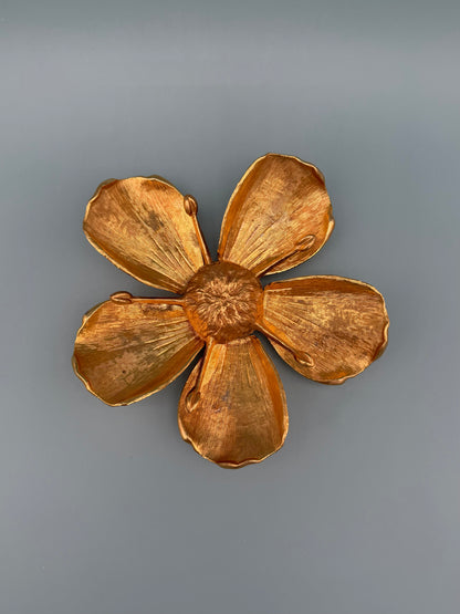 Same gold marigold flower-shaped dish shown alone without the teardrop piece, gray-blue background.