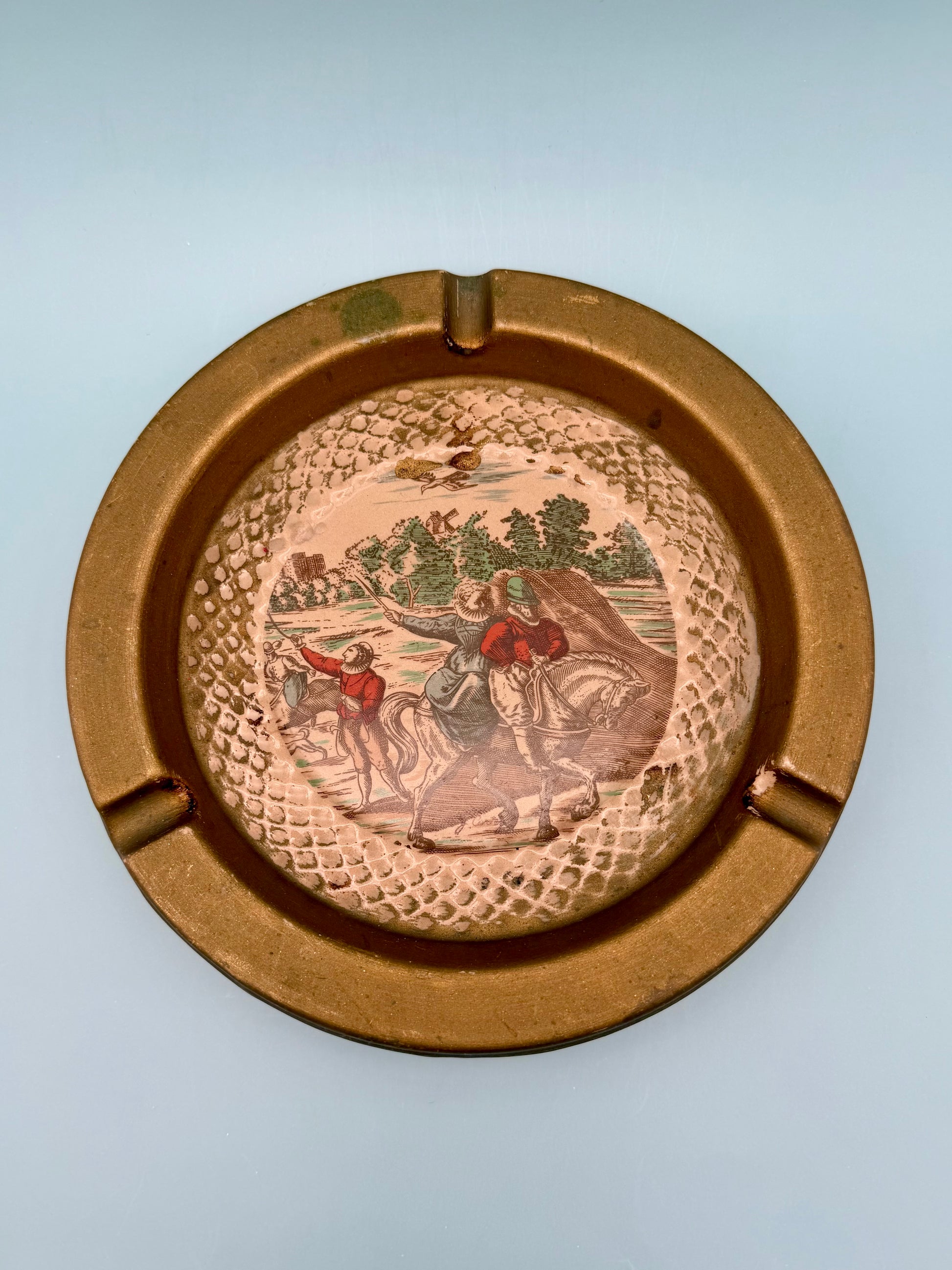 Close-up of the Florentine ashtray's painted landscape scene with horseback riders, gray background