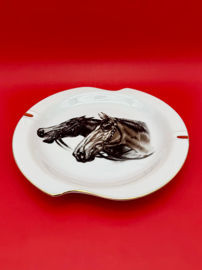 Same horse head portrait ashtray from Duke shown without the cigarette pick, red background.