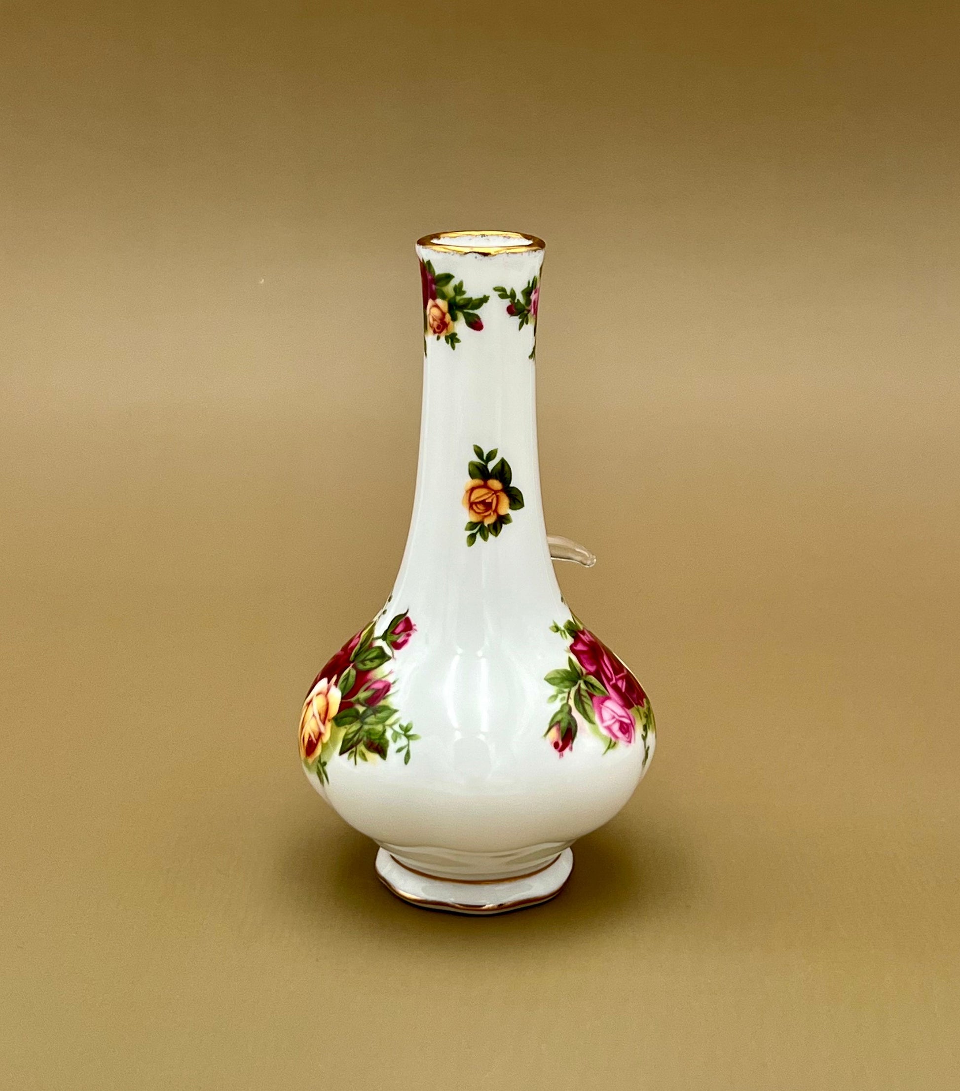 Straight-on front view of the same rose-painted bud vase water pipe showing the bouquet design and gold trim, tan background.