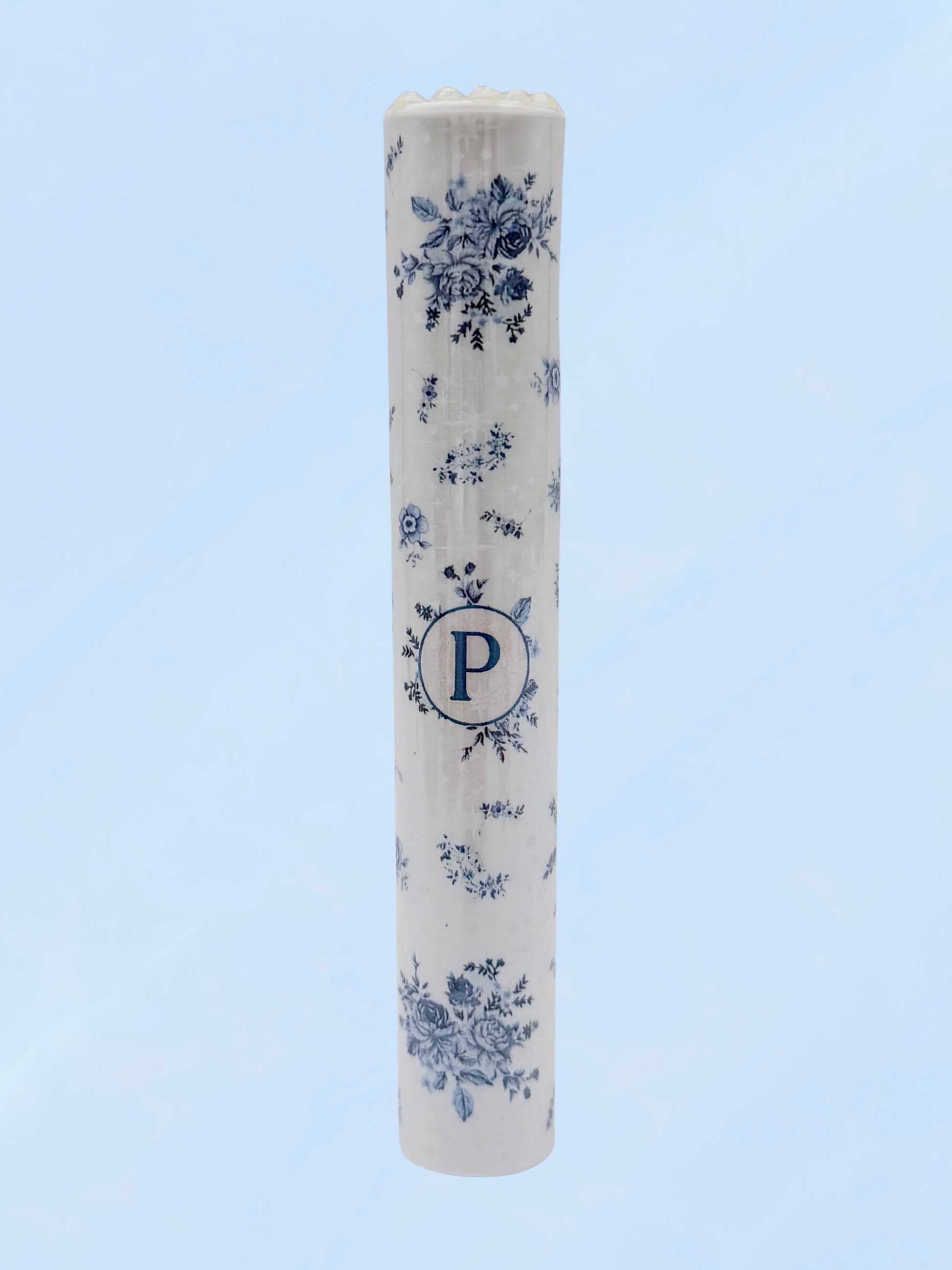 Single blue floral doob tube with rhinestone lid standing upright on a light blue background
