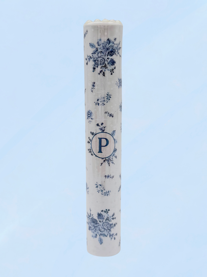 Single blue floral doob tube with rhinestone lid standing upright on a light blue background