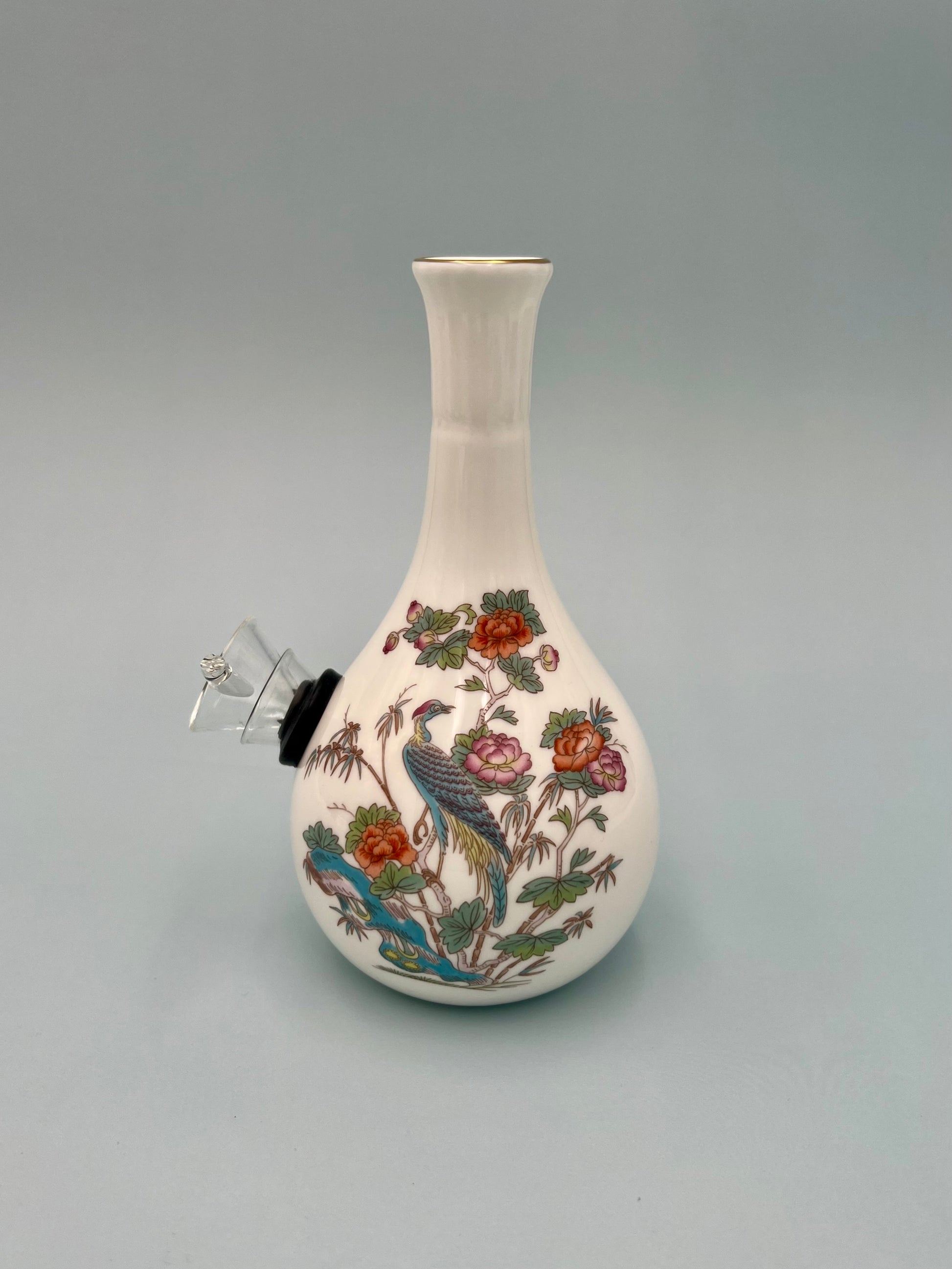 White bone china bud vase water pipe with a painted crane and floral design, glass bowl piece attached at the side, gray background