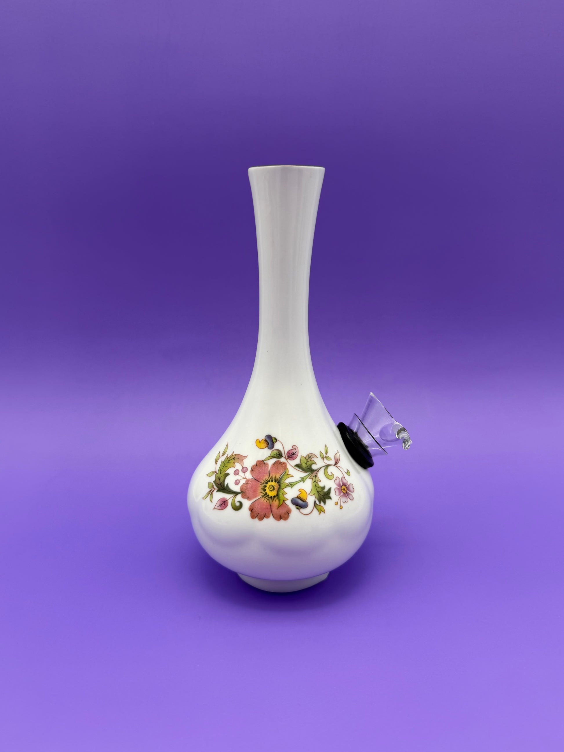 Same bud vase water pipe shown from a side angle, with the glass bowl piece attached and the floral band visible, purple background.