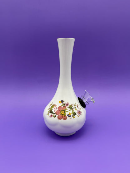 Same bud vase water pipe shown from a side angle, with the glass bowl piece attached and the floral band visible, purple background.