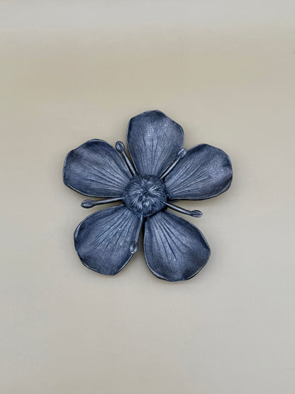 Same silver marigold flower-shaped dish shown alone, tan background.