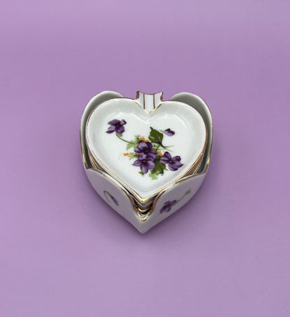 Single heart-shaped porcelain ashtray painted with violets, purple background