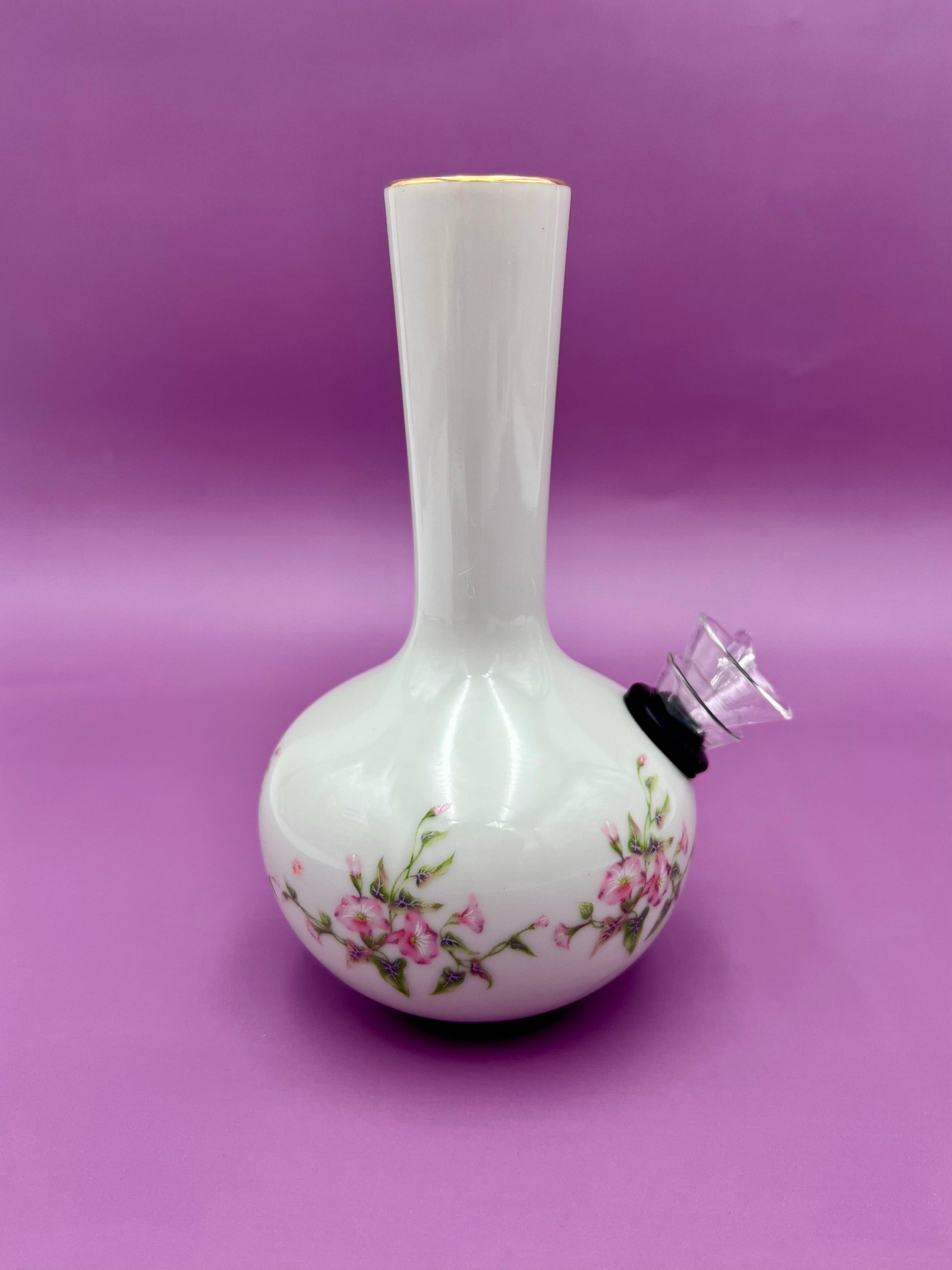 Same white bud vase with the glass bowl piece attached at the side, purple background.
