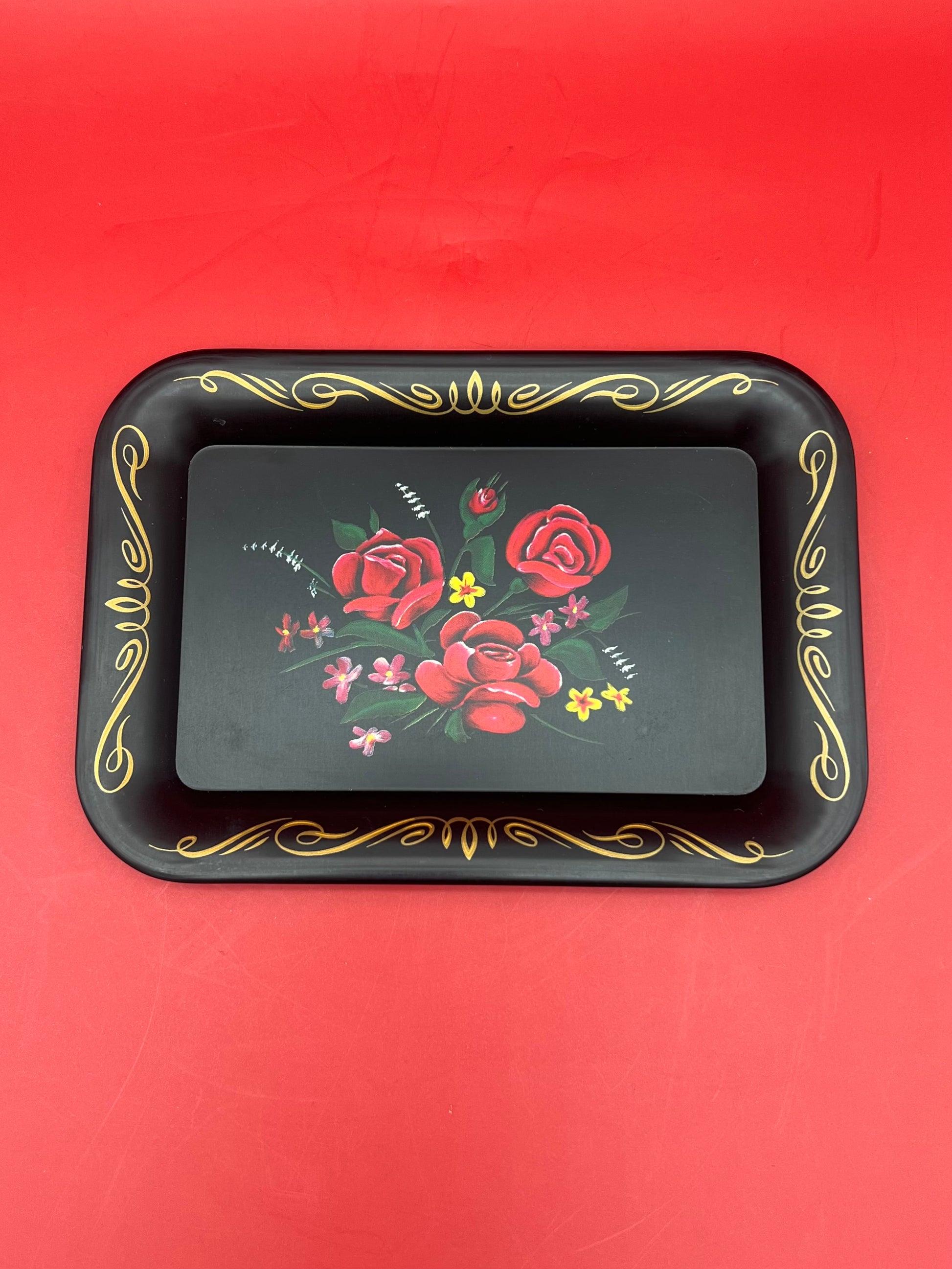 Black rectangular rolling tray with red rose design and gold trim accents